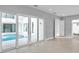 Open-concept living space features tile floors and sliding glass doors for indoor-outdoor living at 6023 Cat Claw Ln, Bradenton, FL 34210