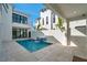 Modern pool area with water feature surrounded by travertine tile, with architecture visible in the background at 6023 Cat Claw Ln, Bradenton, FL 34210