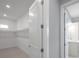 A view into the home's walk-in closet and attached bathroom at 6023 Cat Claw Ln, Bradenton, FL 34210