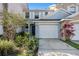 Light blue two-story townhouse with a white garage door and lots of Florida landscaping at 6236 Olivedale Dr, Riverview, FL 33578