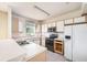 The kitchen has white cabinets and basic appliances at 6236 Olivedale Dr, Riverview, FL 33578