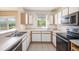 View of the kitchen featuring stainless steel appliances and white cabinets at 6236 Olivedale Dr, Riverview, FL 33578