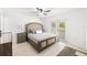 Bright bedroom features neutral decor, ceiling fan, and sliding glass doors to outdoor patio at 6248 Tabogi Trl, Wesley Chapel, FL 33545