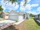 Charming home with a two-car garage, walkway, and well-maintained front lawn at 6248 Tabogi Trl, Wesley Chapel, FL 33545