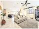 Open-concept living room with tile floors and modern furnishings at 6248 Tabogi Trl, Wesley Chapel, FL 33545
