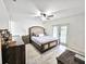 Spacious main bedroom with ceiling fan, tile floors, and french doors at 6248 Tabogi Trl, Wesley Chapel, FL 33545