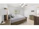 Bedroom with a bed, nightstand, tile floor and a ceiling fan at 6248 Tabogi Trl, Wesley Chapel, FL 33545