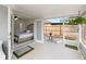 Cozy screened patio with view through sliding glass doors to bedroom at 6248 Tabogi Trl, Wesley Chapel, FL 33545
