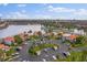 Beautiful aerial view of condos with a parking area surrounded by lush landscaping and a serene lake at 6277 Bahia Del Mar Blvd # 110, St Petersburg, FL 33715