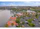 Stunning aerial view of waterfront condos with red tile roofs, lush landscaping, and ample parking at 6277 Bahia Del Mar Blvd # 110, St Petersburg, FL 33715