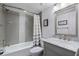 Modern bathroom with gray tiled shower and neutral vanity with lots of light at 6277 Bahia Del Mar Blvd # 110, St Petersburg, FL 33715