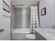 Bathroom featuring a shower and tub combination with gray tile and a marble countertop at 6277 Bahia Del Mar Blvd # 110, St Petersburg, FL 33715