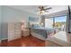 Cozy bedroom with a ceiling fan, wood floors, and a bright window with water views at 6277 Bahia Del Mar Blvd # 110, St Petersburg, FL 33715