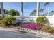 Landscaped community sign for Lakeside Villas featuring lush greenery and bright pink flowers at 6277 Bahia Del Mar Blvd # 110, St Petersburg, FL 33715