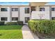 Well-maintained condo exterior with green landscaping, sidewalk, and a building sign at 6277 Bahia Del Mar Blvd # 110, St Petersburg, FL 33715