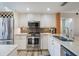 Well-equipped kitchen with stainless steel appliances, granite counters, and tiled backsplash at 6277 Bahia Del Mar Blvd # 110, St Petersburg, FL 33715