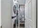 Laundry room featuring a stacked washer and dryer and the home's HVAC system at 6277 Bahia Del Mar Blvd # 110, St Petersburg, FL 33715
