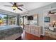 Primary bedroom featuring a ceiling fan and sliding glass doors to the outdoors at 6277 Bahia Del Mar Blvd # 110, St Petersburg, FL 33715
