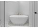 Bathroom featuring modern freestanding tub and beautiful tile flooring at 803 W Woodlawn Ave, Tampa, FL 33603