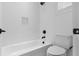Clean bathroom with white subway tile, tub and shower combo, matte black hardware, and white toilet at 803 W Woodlawn Ave, Tampa, FL 33603