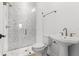 Modern bathroom featuring glass shower with unique tile, toilet, and pedestal sink at 803 W Woodlawn Ave, Tampa, FL 33603