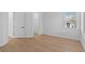 Bright bedroom with hardwood floors, white walls, and multiple windows offering natural light at 803 W Woodlawn Ave, Tampa, FL 33603