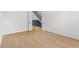 Open doorway leading to the hall and staircase, with wood flooring in the room at 803 W Woodlawn Ave, Tampa, FL 33603