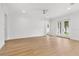 Spacious room with hardwood flooring, double doors to outside, ceiling fan, and neutral paint at 803 W Woodlawn Ave, Tampa, FL 33603