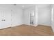Bright bedroom with wood floors, white walls and an attached bathroom with glass enclosed shower at 803 W Woodlawn Ave, Tampa, FL 33603