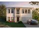 Charming two-story home with landscaped yard, a two-car garage, and manicured shrubs at the front entrance at 803 W Woodlawn Ave, Tampa, FL 33603