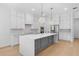 Bright kitchen featuring a large island, stainless steel appliances, and designer pendant lighting at 803 W Woodlawn Ave, Tampa, FL 33603