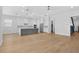 Modern open-concept with stainless appliances, gray island and white cabinets at 803 W Woodlawn Ave, Tampa, FL 33603