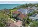 Beautiful home with a tile roof, brick driveway and mature landscaping at 827 N Bayshore Dr, Safety Harbor, FL 34695