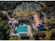 A birds-eye view showcases the pool, clubhouse, tennis courts and playground within the community at 9481 Highland Oak Dr # 1616, Tampa, FL 33647