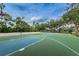 Outdoor basketball court with blue and green surfaces, volleyball court, and basketball hoops at 9481 Highland Oak Dr # 1616, Tampa, FL 33647