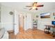 Comfortable bedroom featuring wood floors, ceiling fan, a TV, and decor at 9481 Highland Oak Dr # 1616, Tampa, FL 33647