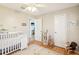 Bedroom showing a white crib, dresser, and decorative elements at 9481 Highland Oak Dr # 1616, Tampa, FL 33647