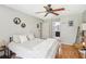 Bedroom featuring wood floors, neutral decor, a ceiling fan, and easy access to a private bathroom at 9481 Highland Oak Dr # 1616, Tampa, FL 33647