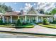 Welcoming clubhouse exterior featuring manicured landscaping, a covered porch, and elegant architectural details at 9481 Highland Oak Dr # 1616, Tampa, FL 33647