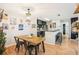 Cozy dining room with a wooden table, stylish lighting, and access to the kitchen at 9481 Highland Oak Dr # 1616, Tampa, FL 33647