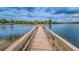 Wooden dock extending over calm lake, great for fishing, sunset views, and nature enjoyment at 9481 Highland Oak Dr # 1616, Tampa, FL 33647
