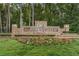 Hunter's Green community sign with beautiful landscaping, stone accents, and elegant lettering at 9481 Highland Oak Dr # 1616, Tampa, FL 33647