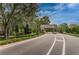 Inviting entry gate surrounded by mature trees and manicured landscaping creates a sense of arrival at 9481 Highland Oak Dr # 1616, Tampa, FL 33647