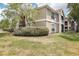 Well-manicured lawn and facade on this condo featuring beautiful landscaping and natural light at 9481 Highland Oak Dr # 1616, Tampa, FL 33647