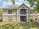 Charming exterior showcasing the architecture with balcony, windows, and well-maintained lawn at 9481 Highland Oak Dr # 1616, Tampa, FL 33647
