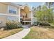 Inviting condo exterior featuring a private entrance, mature landscaping, and a well-maintained facade at 9481 Highland Oak Dr # 1616, Tampa, FL 33647