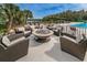 Outdoor fire pit area with comfortable seating, perfect for relaxing and socializing at 9481 Highland Oak Dr # 1616, Tampa, FL 33647