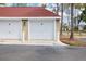 Detached garage with white doors, offering convenient parking and storage space for residents at 9481 Highland Oak Dr # 1616, Tampa, FL 33647