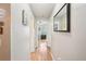 Bright hallway with a large mirror and views into other rooms with neutral decor at 9481 Highland Oak Dr # 1616, Tampa, FL 33647