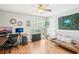 Bright home office featuring wood floors, a large window, modern decor, and a comfortable couch at 9481 Highland Oak Dr # 1616, Tampa, FL 33647